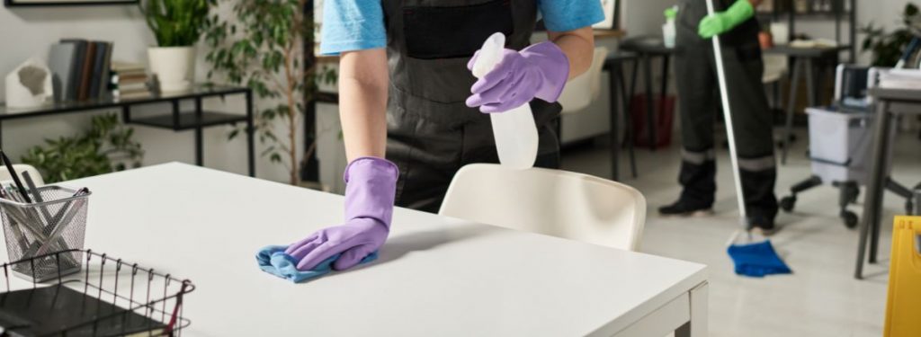 Technician spraying desk